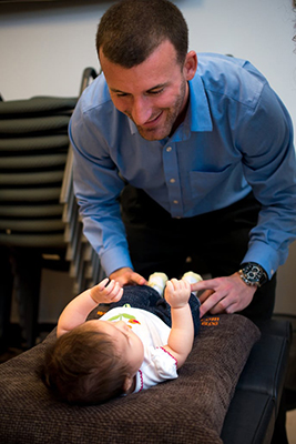 Chiropractor Boynton Beach FL Andrew Nolt Adjusting Baby